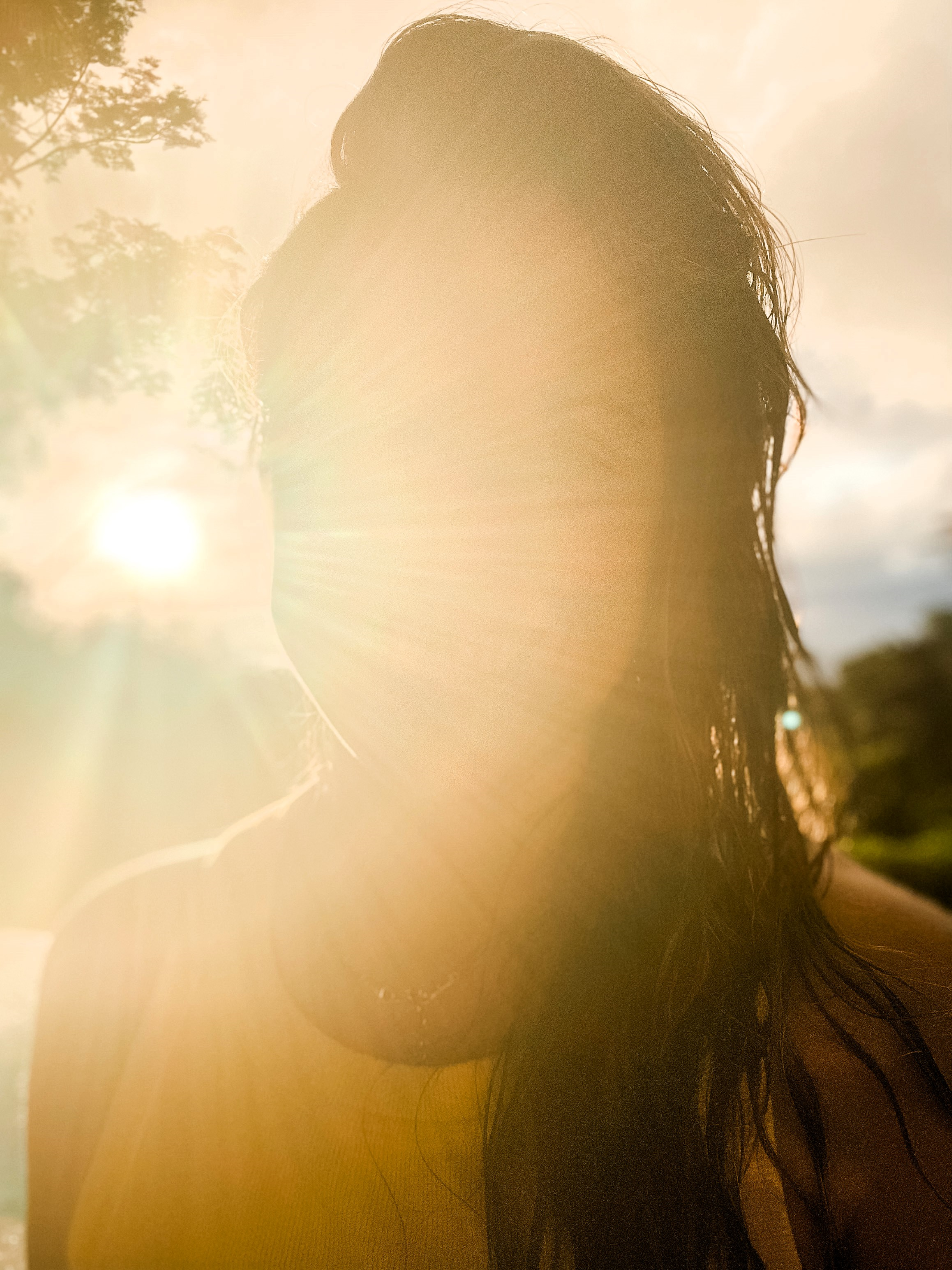 Photo of Ashley with sunbeams shining over her face